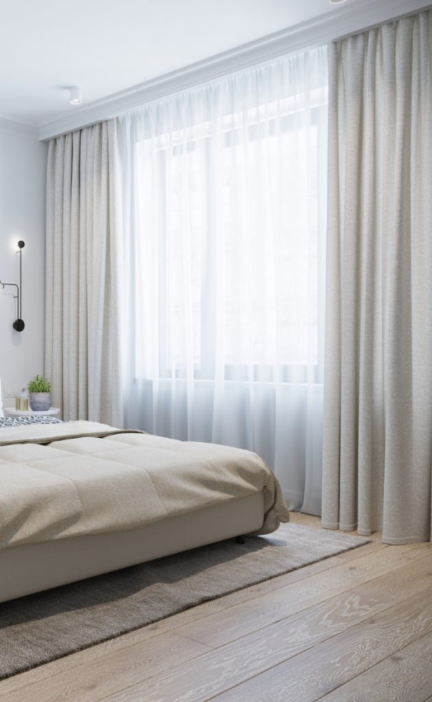 Showing blockout and sheer curtains paired over bedroom window for soft light control