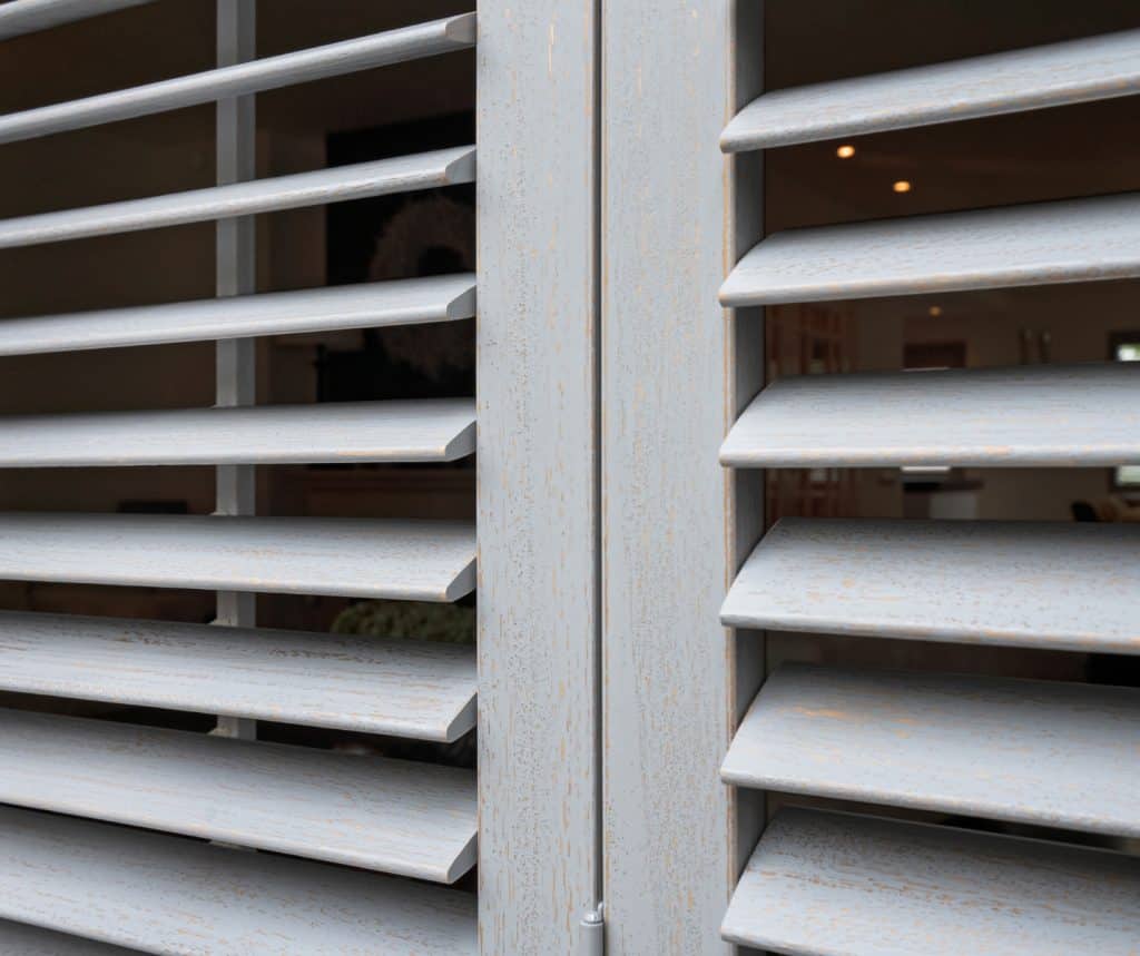 Showing close-up of Paulownia shutter blades with smooth painted finish and visible timber grain texture.