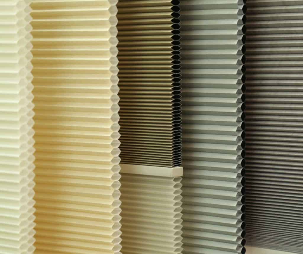 Showing close-up of colour options in honeycomb blinds fabric samples.