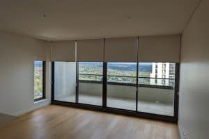 Showing a highrise apartment interior with new window coverings installed.