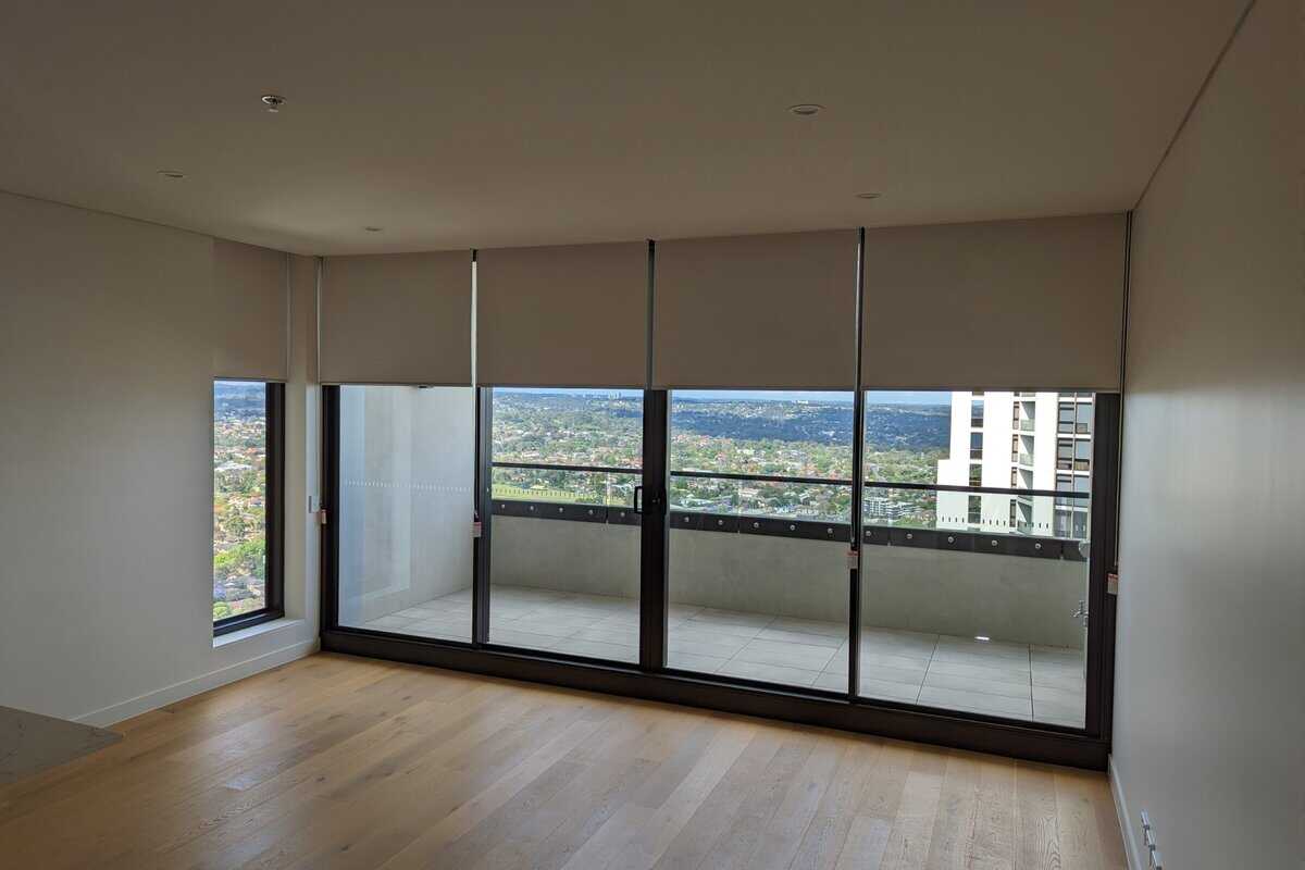Showing a highrise apartment interior with new window coverings installed.