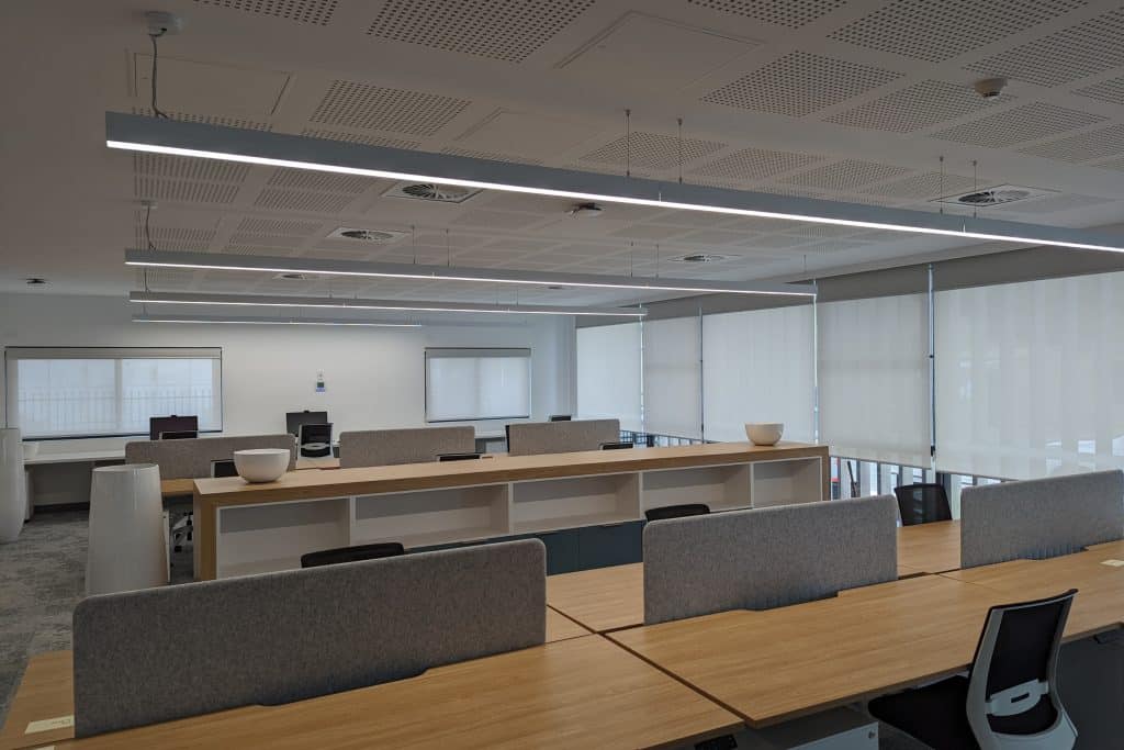 Showing a modern open-plan office workspace for a project fitout with window coverings.