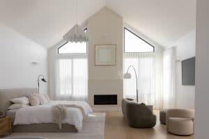 Showing sheer curtains framing tall windows in a modern bedroom with soft natural light.