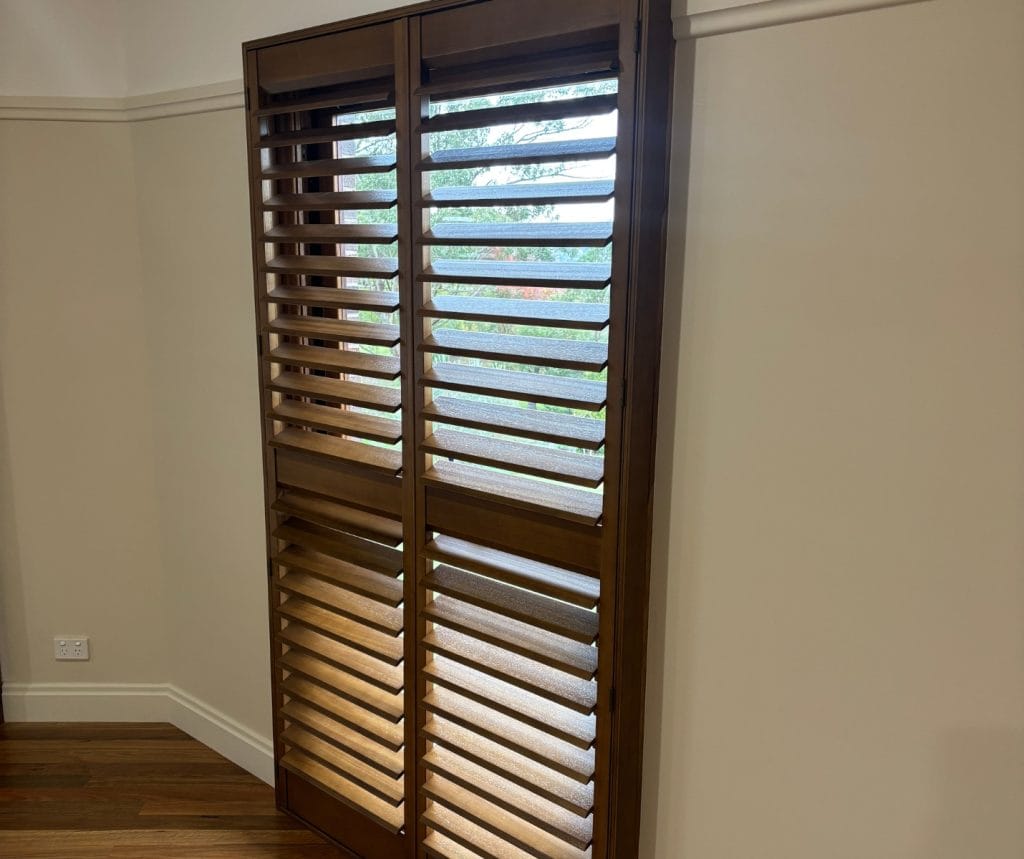 Showing timber heritage shutters in a traditional room with polished floorboards and cream walls