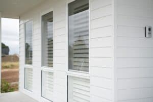 Showing white interior plantation shutters fitted to tall windows, providing privacy, light control and a clean finish.