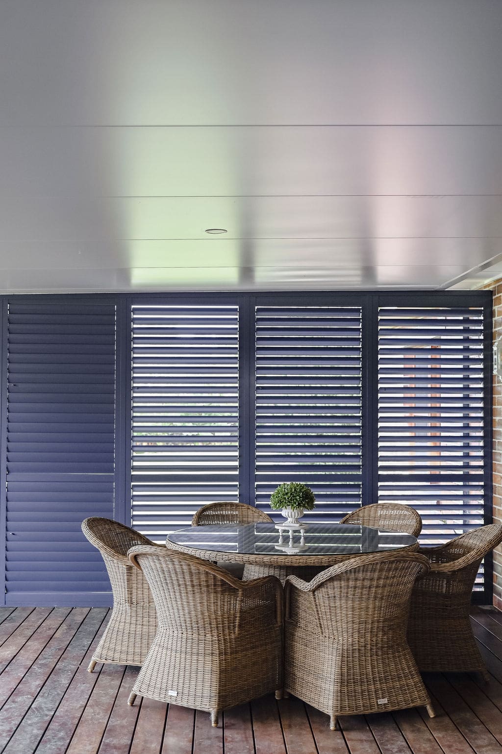 Showing outdoor aluminium plantation shutters in an alfresco area, providing privacy, shade and weather protection with a modern finish.