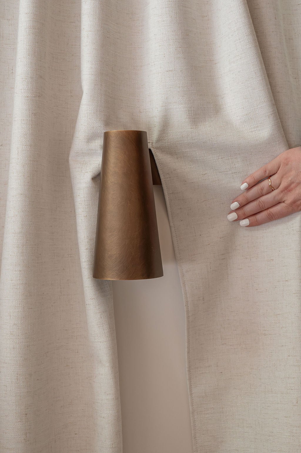 Custom blockout curtains with tailored slits neatly accommodate wall-mounted sconces while maintaining privacy and a seamless finish.