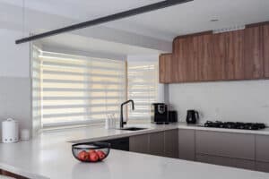 Showing PerfectSheer blinds in a modern kitchen with corner windows, filtered natural light and sleek cabinetry for everyday privacy.