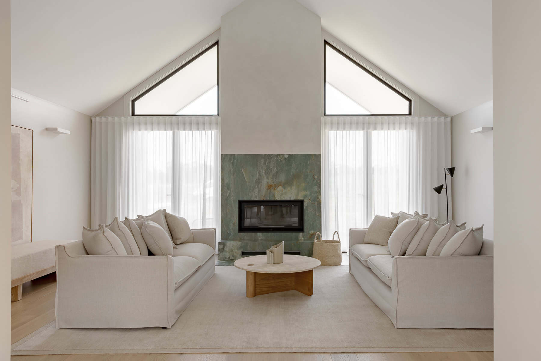 Showing floor-to-ceiling sheer curtains in a modern living room, filtering natural light and creating a bright, private and welcoming space.