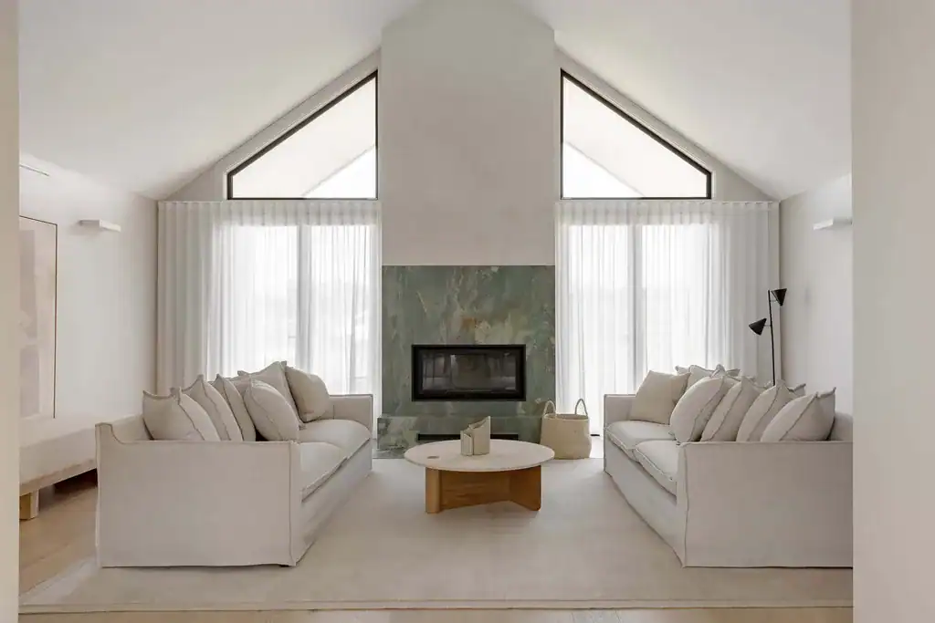 Sheer curtains in a vaulted living room with a green stone fireplace, Lakesland